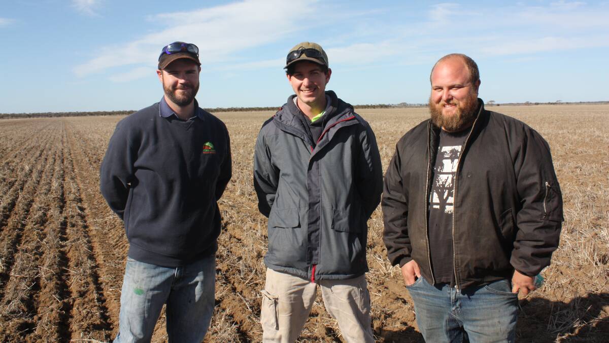 Kulin farmers Tim Barndon (left), Mitchell King and Lacky Siviour watching the Seed Storm rig in action at Gnowangerup last week.