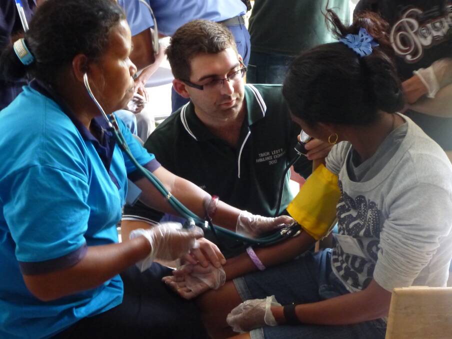 Ben Small delivering ambulance services and training in Timor L'Este in an exchange program.