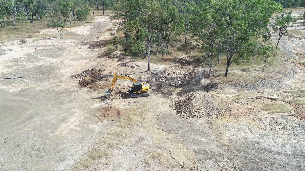 Rock structures built at an old tailings dam wall will stop a gully from continuing to erode.