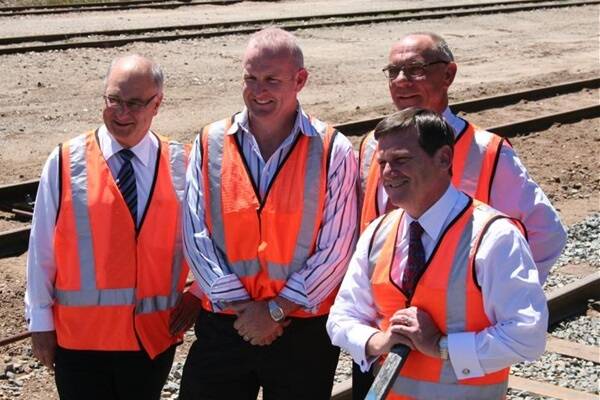  Agricultural MLC Brian Ellis (left), WestNet Rail chief executive officer Paul Larsen, Agricultural MLC Jim Chown and Transport Minster Simon O'Brien installed a clip to a silver railway sleeper to signify the start of the grain freight network upgrade to the Great Southern railway line.