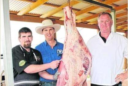 With a Charolais cross heifer carcase before it was cut up at last week's Charolais field day were The Beef Shop's butcher Russell Taylor (left), Dean Ryan, who hosted the event and The Beef Shop owner Kevin Armstrong.
