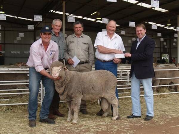 With the $6800 top-priced Poll Merino ram at last week's Willemenup sale were Willemenup co-principal Collyn Garnett (left), stud consultant Ken Littlejohn and buyer Bill Cowan, Crichton Vale stud, Mount Walker. With them is Dick Garnett handing over a cheque for $6800 to the endorsed Liberal candidate for the Federal seat of O'Connor, Rick Wilson.
