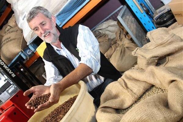 Patrick McSweeney with some of his freshly roasted coffee beans at the Naked Bean in Albany.