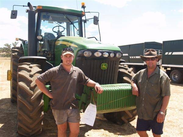 Pictured with the top priced item of the sale the John Deere 8520 tractor which they bought were Braden (left) and Ken Grylls, Corrigin.