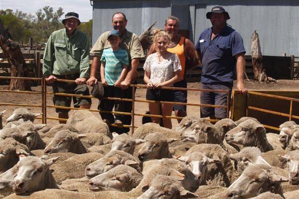 With some of the line of 484 orange tag ewes, which topped the clearing sale offering at $49.50, were local Landmark agent and sale co-ordinator Chris Turton (left), vendors, Ian and Neville Giles and Ian's son Jack and daughter Breanne and buyer Scott Packer, Packer & Sons, Yealering.