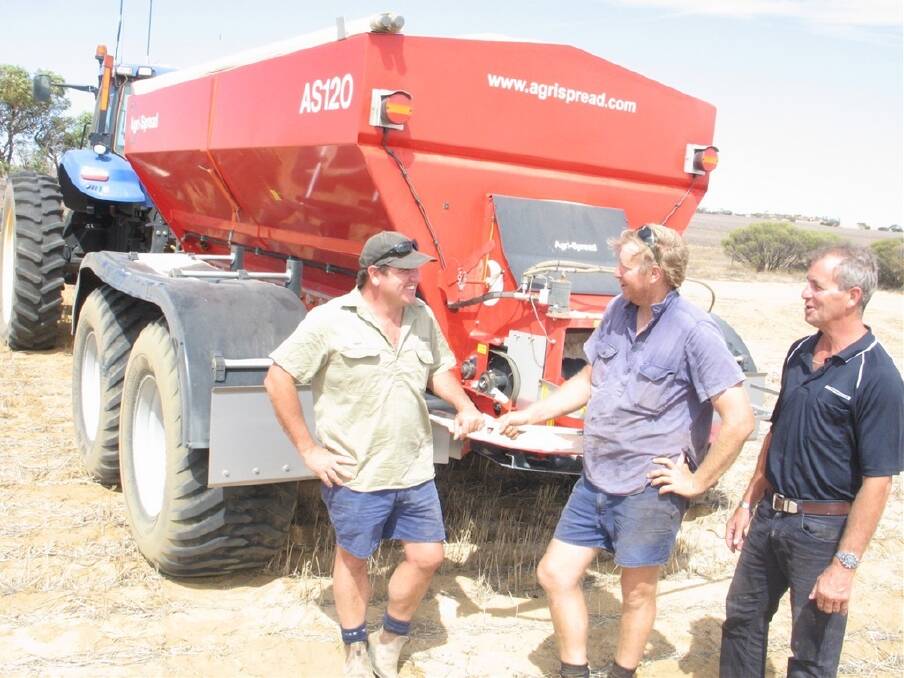 Yuna farmer and Agrispread Australia director John Warr (left), discusses the features of the Agrispread spreader with east Yuna farmer Greg "Jack" Creasy and McIntosh & Son salesman Dale Fowler.
