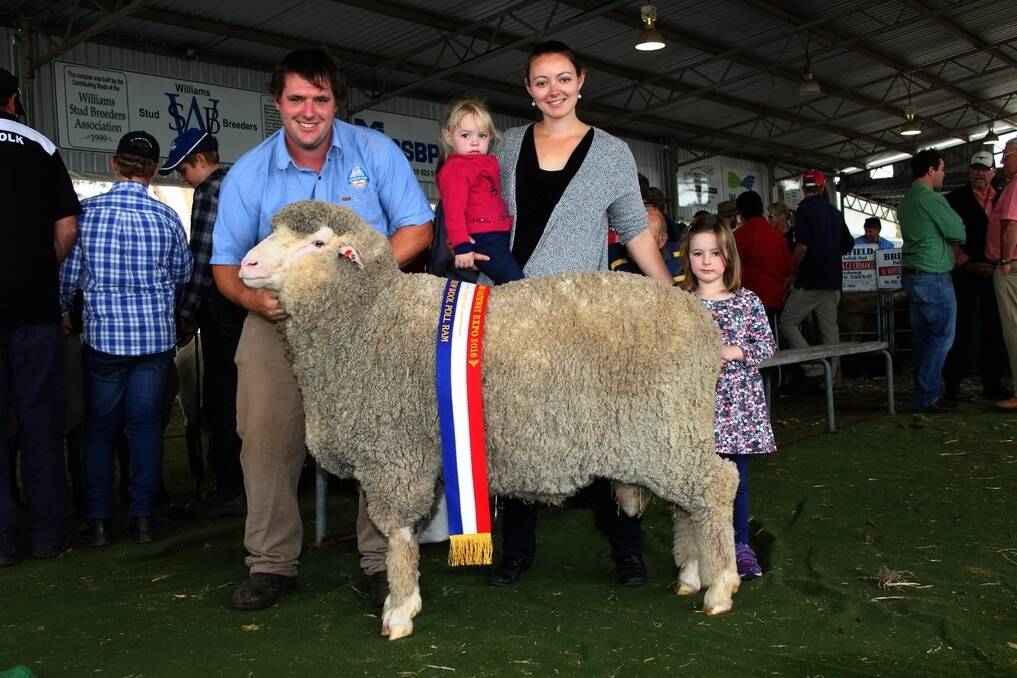 Clinton Blight, wife Sarah, and their two daughters Aticia and Katie, Seymour Park stud, Highbury, with their champion medium wool Poll Merino ram.