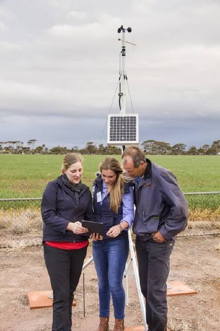  DAFWA development officer Katherine Davies with Moorine Rock growers Erin and Tim Pope at the automatic weather station on Merredin Research Station.