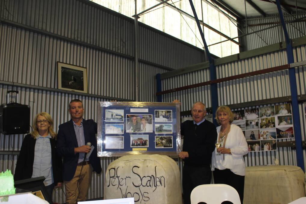 Peter Scanlan Wool's longest serving staff members Karen Smith and Darren Shivers (left) present company founders Peter and Margaret Scanlan.