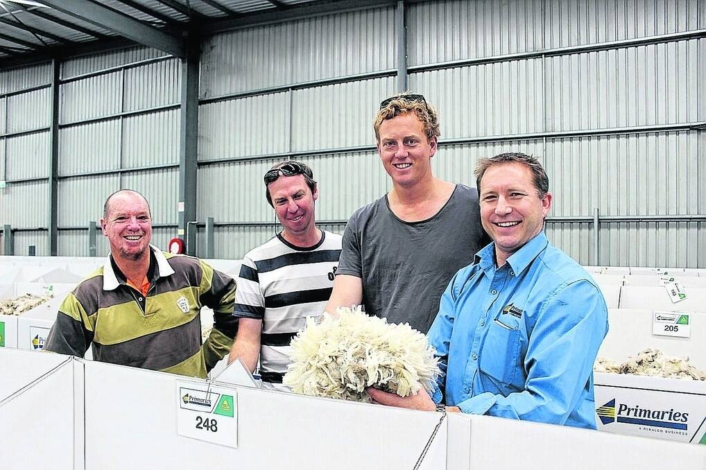 Kevin McLean, Bankia Downs, Coomberdale, visiting South African woolgrower Frank Ekron and Duncan Glasfurd, Warruga, Cataby, are shown over the Primaries of WA woolstore by wool manager Greg Tilbrook.
