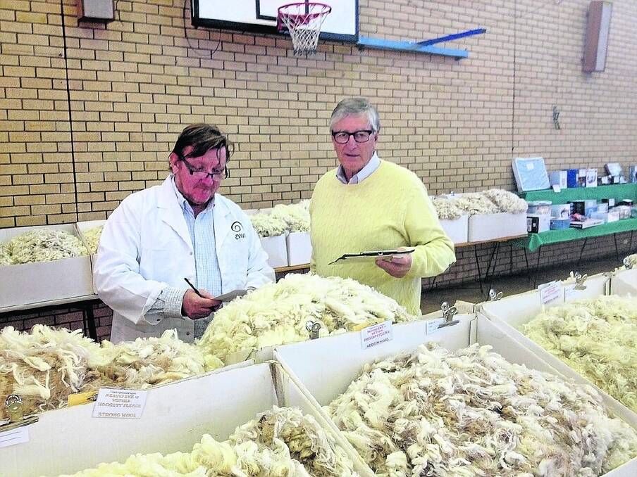 NSW wool judge Scott Carmody (left) and Australian Wool Innovation director David Webster judging fleeces at this year&#39;s Yilgarn Agricultural Show, Southern Cross.