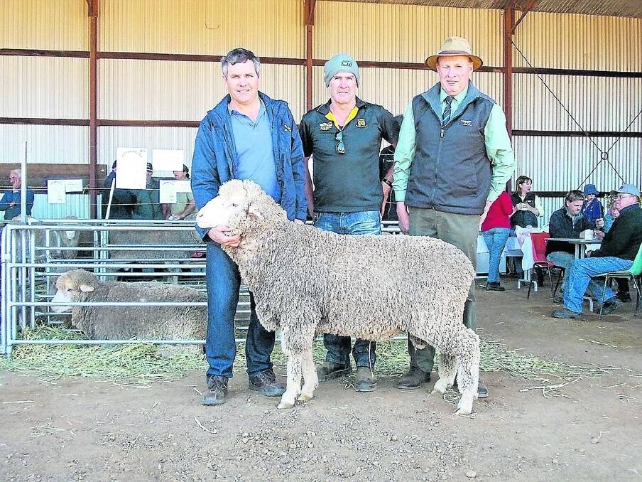 Parakeelya co-principal Andrew Dunne (left), Beacon, Mark Ward, Wyakatchem, buyer of the top priced ram, which fetched $2200 and Landmark auctioneer Grant Lupton.