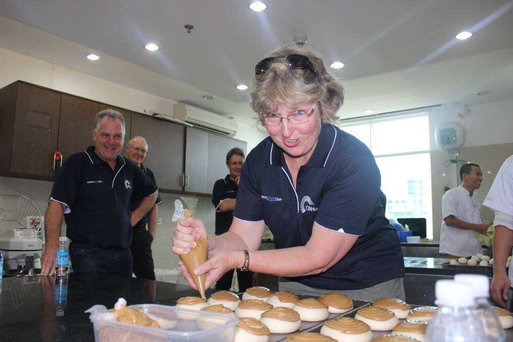 Lyn Bassett, Brookton, tries her hand at decorating Vietnamese sweet buns during a bread-making demonstration at the Interflour Vietnam's head office in Ho Chi Minh City during the CBH grower study tour.