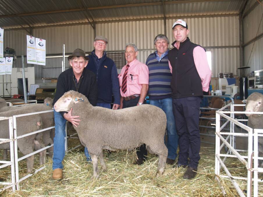 Far Valley stud principal David Kain holding the top-priced ram which sold for $2700, with him is buyer, Richard Creek, Creek Farms, Boyup Brook, Elders auctioneer Preston Clarke, Dohne assessor Murray Drage and Elders Williams branch manager Shane Medlen.
