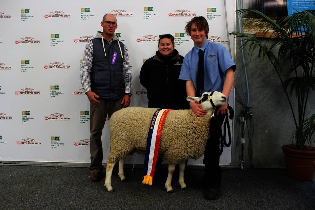 Judge Colin Holmes of Coljac Border Leicester stud, Hyden, Esperance Farm Training Centre&#39;s Escolar stud principal Emily McDonald and year 10 student handler Dylan Molloy with the Border Leicester champion ewe at this year&#39;s IGA Perth Royal Show.