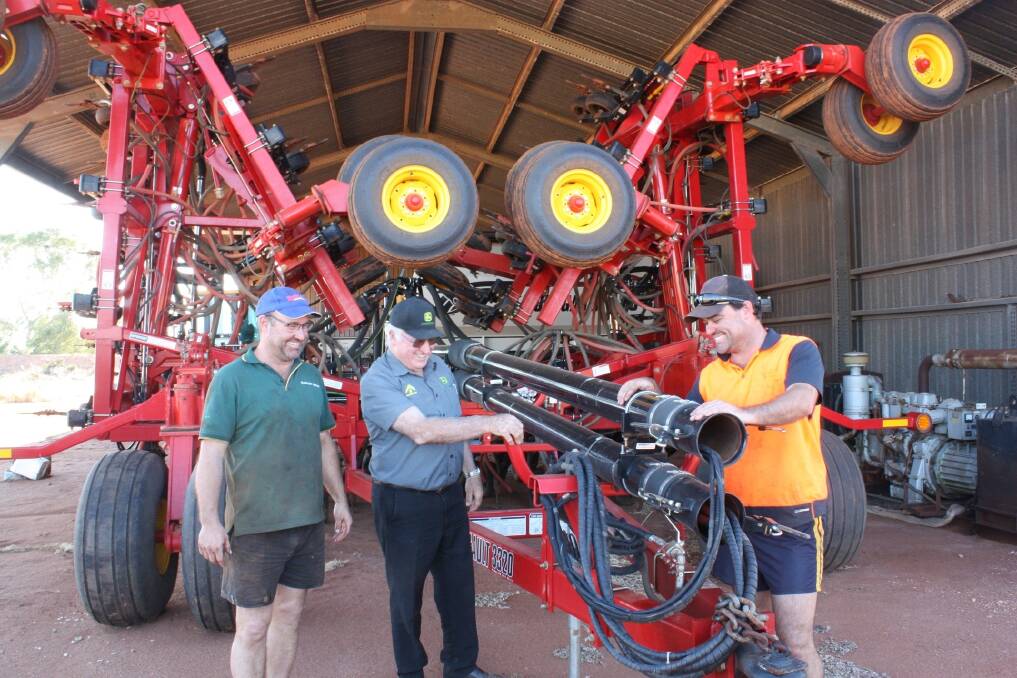 Ag Implements Mukinbudin branch manager Errol McGrath (centre) is flanked by Bonnie Rock farmers Trevor (left) and Scott Watson.