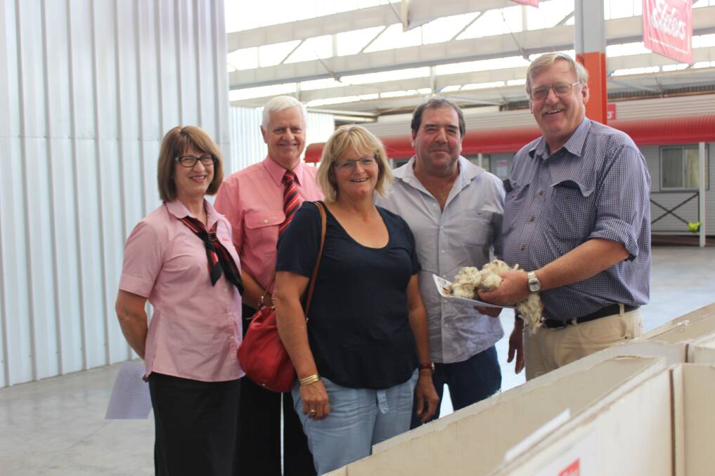 Heather Steel and Rob Young, Elders, with Sue and Scott Pickering, Derella Downs and Pyramid Poll Merino Stud, Cascade, and Rod Taylor, Epasco Farms, Condingup, inspecting wool on the Elders show floor last week.