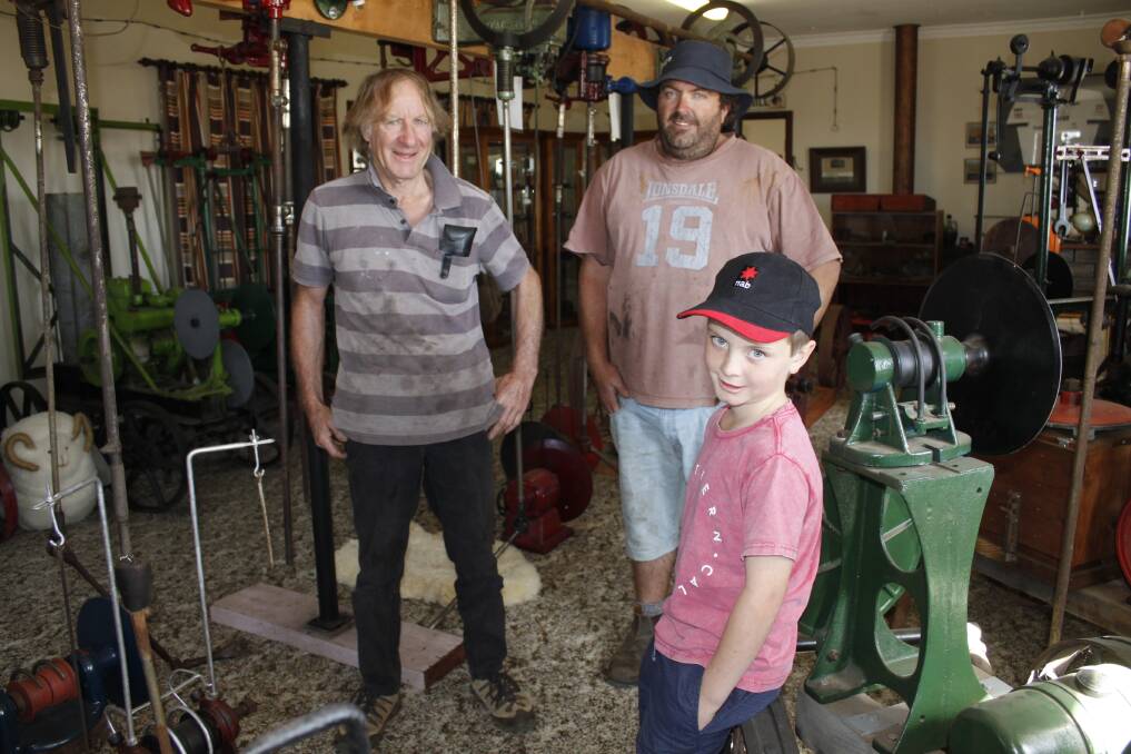 Three generations: Alex (left) and Cameron Cant with Cameron's son Matthew, 7, in part of Alex's unofficial wool museum which houses a wide range of historic handpieces, shearing plants, photographic memorabilia and presses collected from across the country.