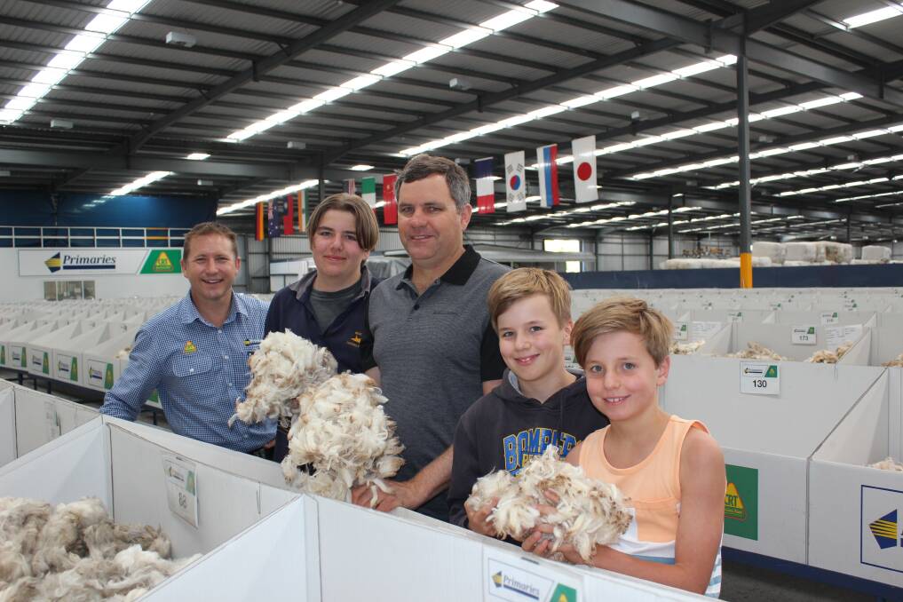 Primaries of WA wool manager Greg Tilbrook (left) with Andrew Dunne, Beacon, and sons Matt, 15, Nathan, 11, and Lachlan, 9, who stopped off to inspect their wool samples on the Primaries show floor while on their way through to Dunsborough for their annual holiday.