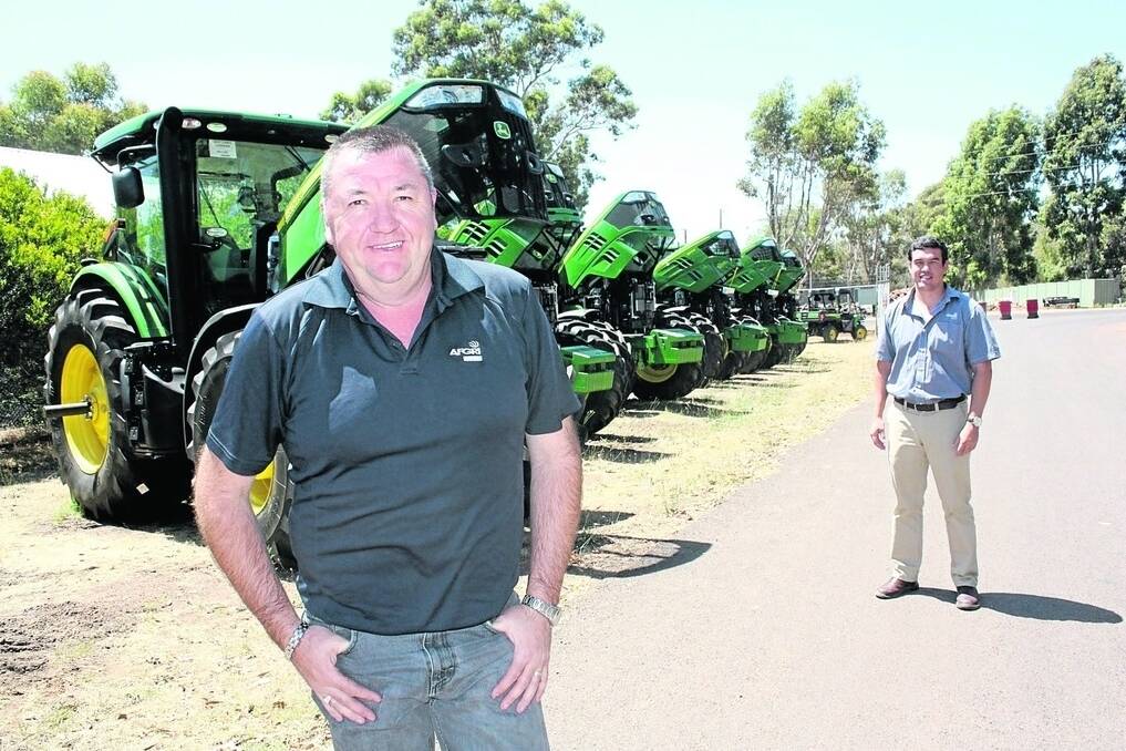 AFGRI Equipment Boyup Brook and Witchcliffe branch manager Darren Newbey, with company marketing manager Jacques Coetzee, next to a line-up of John Deere 7R tractors.