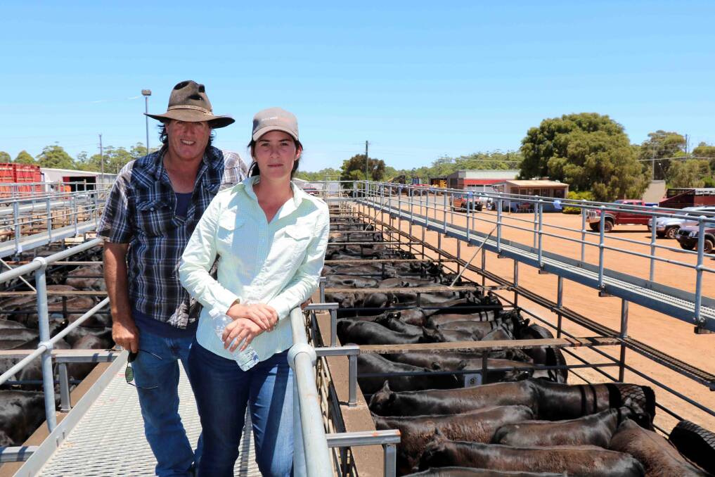Mal (left) and Lyndsay Phillips, inspect the many pens of weaners they trucked to the sale. Their steer calves sold to $1472, with their sought-after heifers topping at $1508.