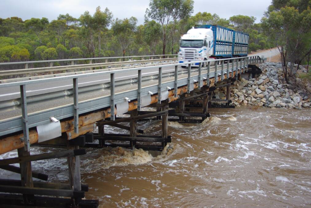 One of the last trucks to cross the Phillips River Bridge, west of Ravensthorpe last Friday. The State's freight network was also heavily impacted by flooding.