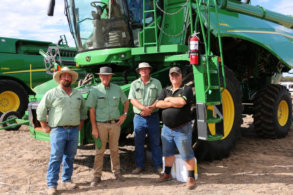 Discussing the success of the sale in front of the top-selling item of the day, a 2015 model John Deere S680 combine harvester with a John Deere 640D front, which sold for $465,000, were Ratten and Slater representative Mark Bratten (right) and the Landmark Esperance Brindley and Gale team consisting of Peter Gale (left), Neil Brindley and Simon Norsworthy.