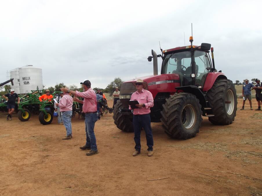 Elders auctioneer Dean Hubbard (centre), knocked down this Case MX210 FWA for the day's top price of $40,000.