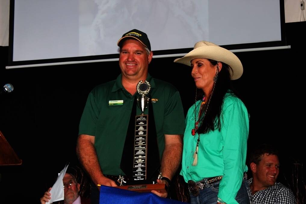 Leigh Ballard from Ballard Seeds, Narrogin, accepts the Best Exhibitor On The Grounds trophy from past rodeo queen Jo Kestel.