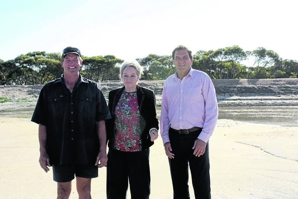 Dunn Rock farmer Darren Wiech (left), with Agriculture and Food Minister Alannah MacTiernan and her parliamentary secretary Darren West. The trio stand in front of Mr Wiech&#39;s key dam that has filled with silt.