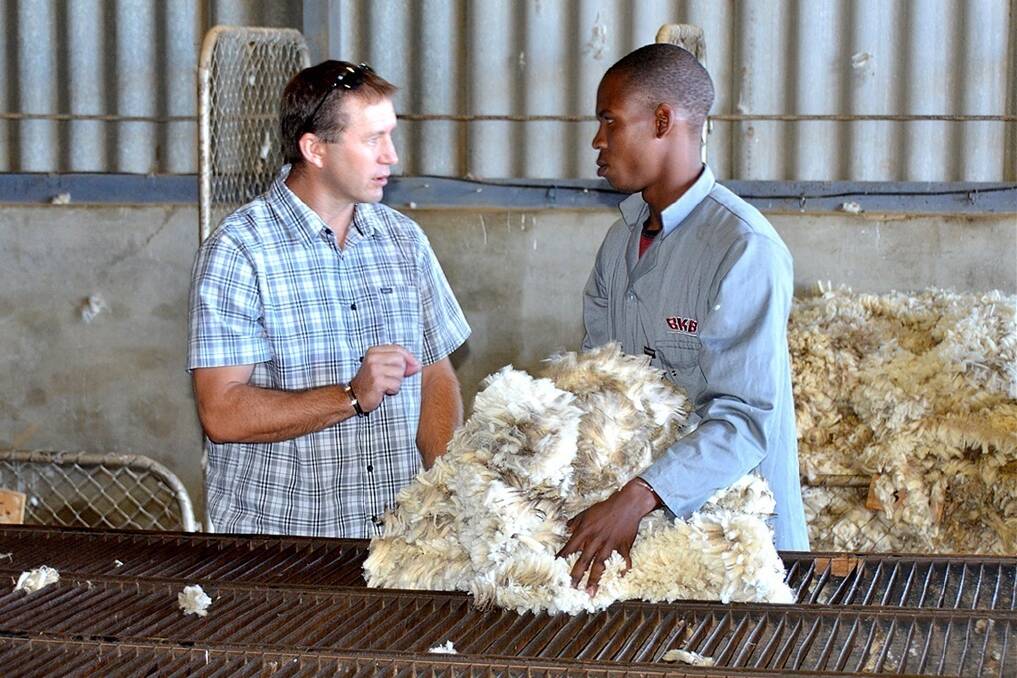 Primaries wool manager Greg Tilbrook (left), chatting to a BKB classer on a farm in the Eastern Cape in South Africa in 2014, when he travelled there as part of winning the National Council Wool Selling Brokers Association Wool Broker award.