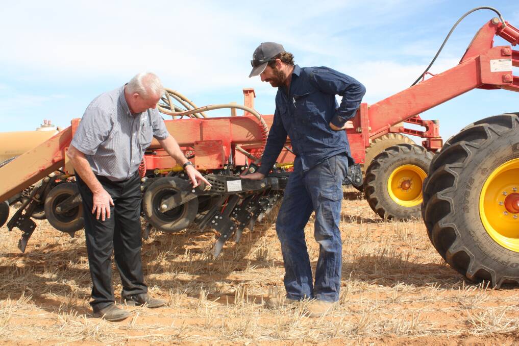AFGRI ag sales manager Ray Trinder (left) and Dalwallinu farmer Michael Sawyer discuss the performance of one of the Bourgault 3320 Paralink High Flotation Hoe Drills during a break in the seeding program earlier this month.