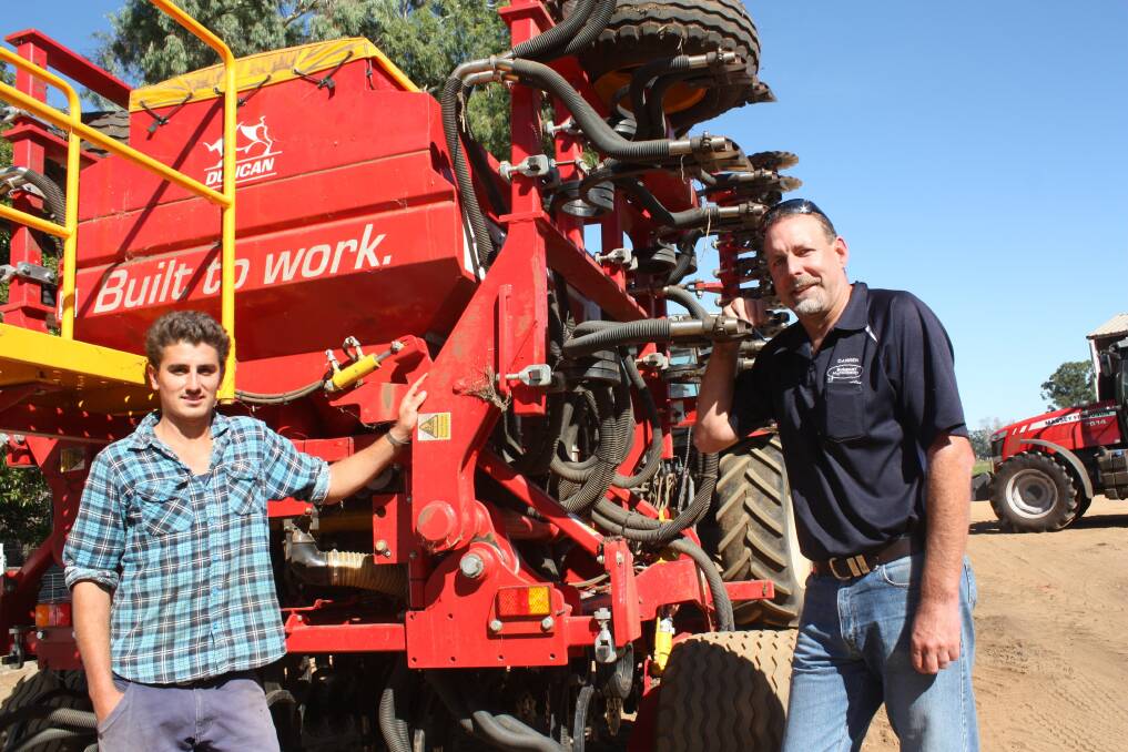 Tutunup dairy farmer Brodie Armstrong (left), and Bunbury Machinery branch manager Darren Pulford with the Duncan AS5300 air seeder "at rest" and waiting for rain after completing more than half of a 890 hectare (2200 acre) program since April 1.