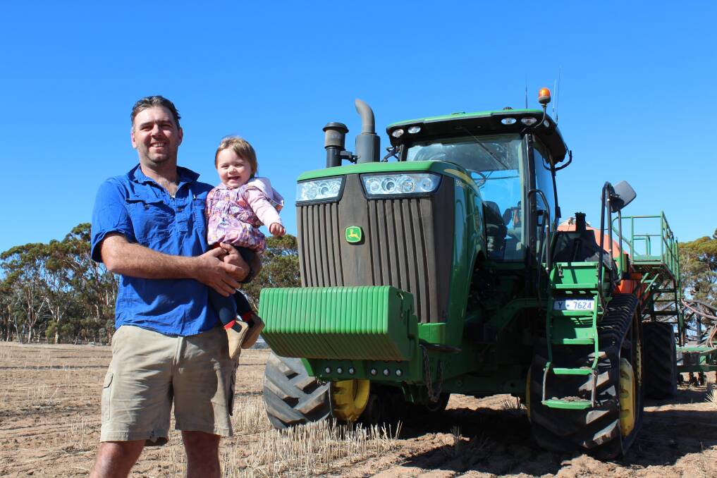 York farmer Guydan Boyle (left) with 13 month old daughter Sophie. Mr Boyle said a lack of government departmental knowledge was creating confusion on whether tracked tractors, such as the John Deere 9560RT pictured, can be driven on public roads.