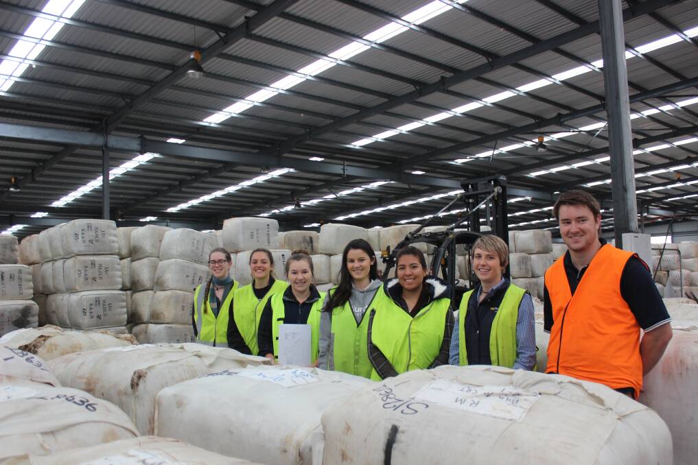 Murdoch University animal science students Shona Hay (left), Jamie Nykiel, Tessa Williams, Leah Sackville and Amanda Ortiz on a guided tour of the Primaries of WA wool store with Esperance wool broker Vicky Hempsell and wool technician Mark Boxall.