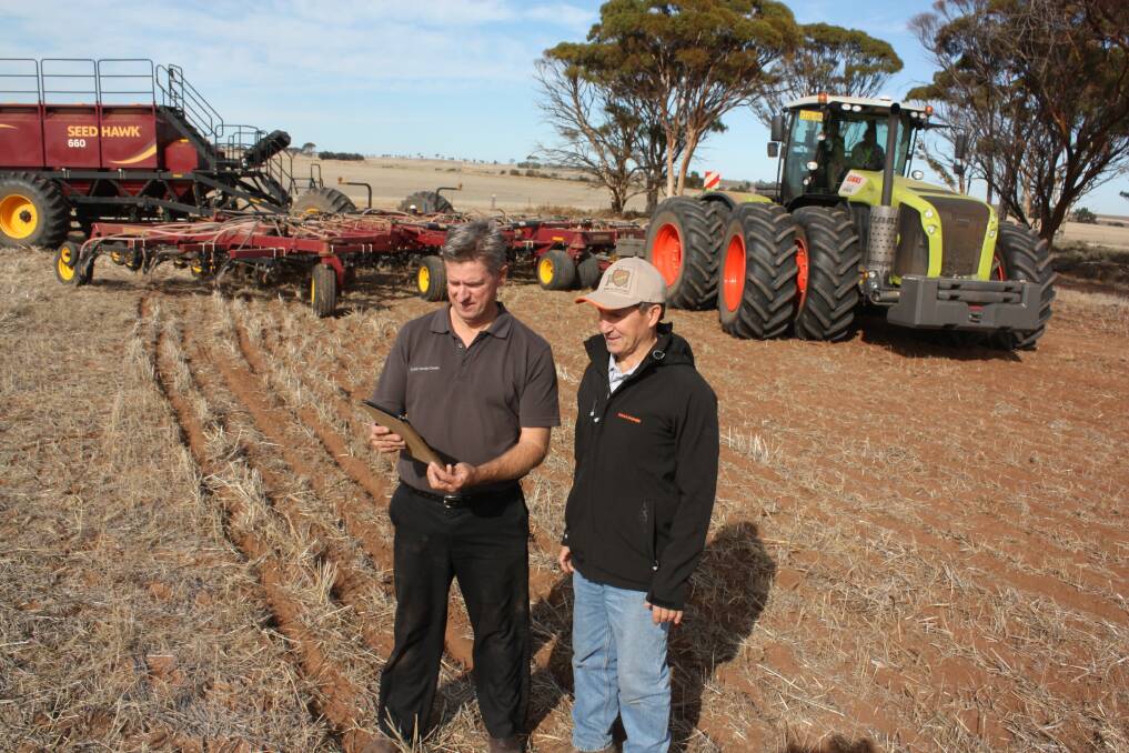 WA Seed Hawk product specialist Russell McCagh (left) remotely configures the iCon Seed Hawk air cart using a wi-fi app on his iPad. Watching is CLAAS Harvest Centre Northam salesman Murray Jones.  