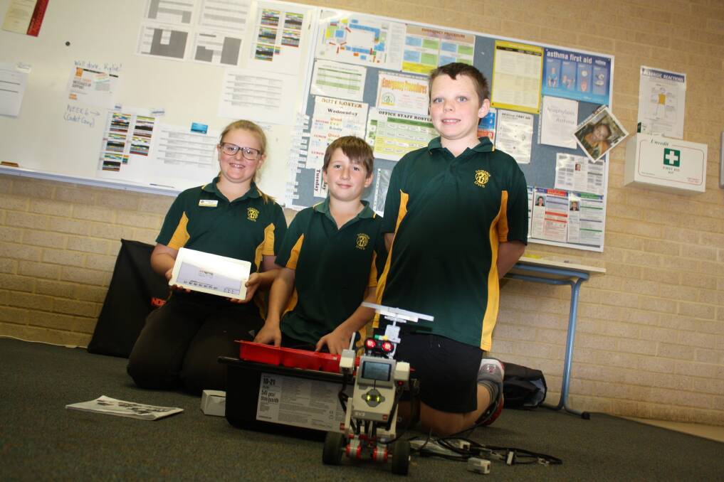 Dowerin District High School Year 6 students Matilda Waugh (left), Zavier Millstead and Year 5 student Evan Prior with their tools of trade in their robotics class.