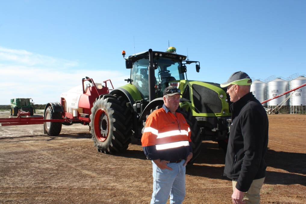 Hassad Australia farm manager Tony Stringer (left), Beaumont and CLAAS Harvest Centre Esperance salesman Luke Kirchner discuss the performance of the new 930 Axion tractor Tony purchased this year.