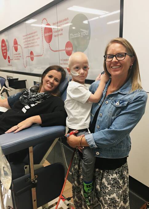 Kellie Bell (left) donating plasma at the Cannington Red Cross Donor Centre, with a special visit from Keren and Leo Baker.