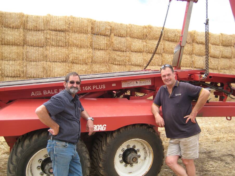  Geoff Perkins (left), Geoff Perkins Farm Machinery Centre, Narrogin, and SP Hay WA general manager Rob Pauley, with one of the company's ProAG 16k Plus Bale Runners. 
