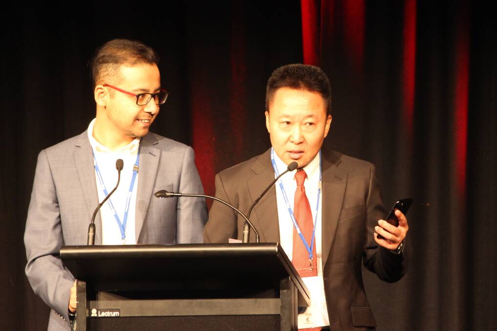  JMM interpreter Aydit Adil (left) with Amaranth Ecological Technology Co Ltd (AET) chairman Tao Yang announcing the deal between AET and the Southern Dirt grower group during Techspo in Katanning last week.