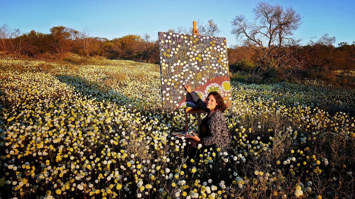 Helen Ansell paints her wreath flower piece out in the field in the stunning Mid West.