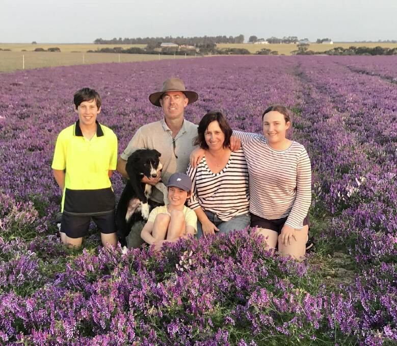 The Roberts family pictured in a flowering 'crop' of Capello vetch in October. From left, Angus, Raf the dog, Archie (sitting), Mark and Marcela Roberts and Lucy. 