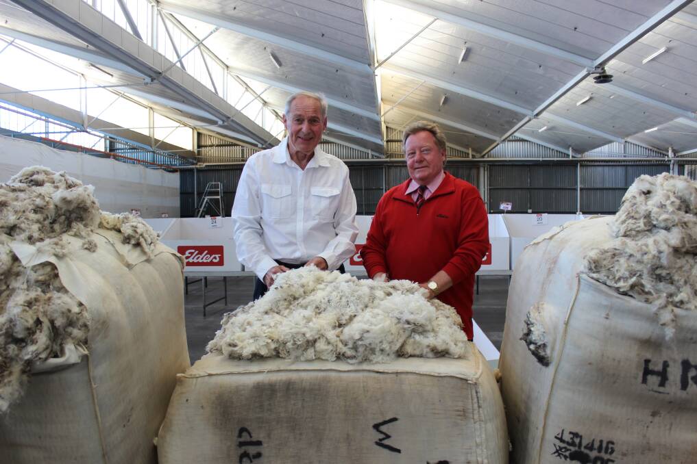 Wool buyer Alan Brown (left) and wool broker Tim Burgess with the top-priced superfine wool from the Elders catalogue so far this year, produced by Peter and Robyn Tilbrook, The Laurels, Darkan.