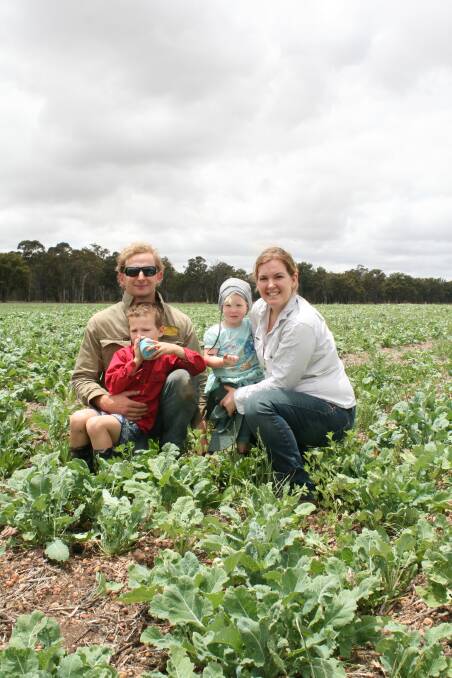  Ben Webb (left) with son Robbie (5), daughter Georgia (2) and his wife Emily in their summer crop; a mix of Chicory, leafmore forage, Plantain, Lucerne, Millet and subclover.