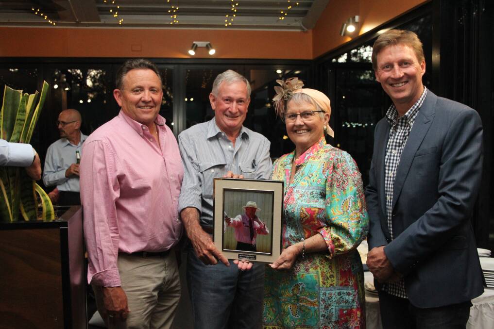 Elders real estate sales executive WA rural Jim Sangalli (left), with Malcolm French, his wife Denise and zone general manager – west, James Cornish, after they presented Mr French with a photo of himself in action auctioneering and an Akubra leather overnight bag marking his retirement after 52 years of service with Elders.