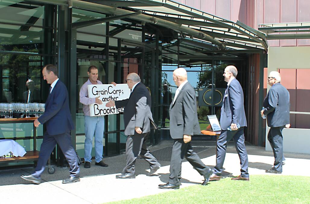 CBH directors entering the 2016 annual meeting shake hands with a lone grower protesting at the Australian Grains Champion bid for control of CBH with backing of major competitor GrainCorp. It was the genesis for CBH asking members at this year's annual meeting to approve a rule change requiring at least half of its members to vote on any significant structural change decisions.