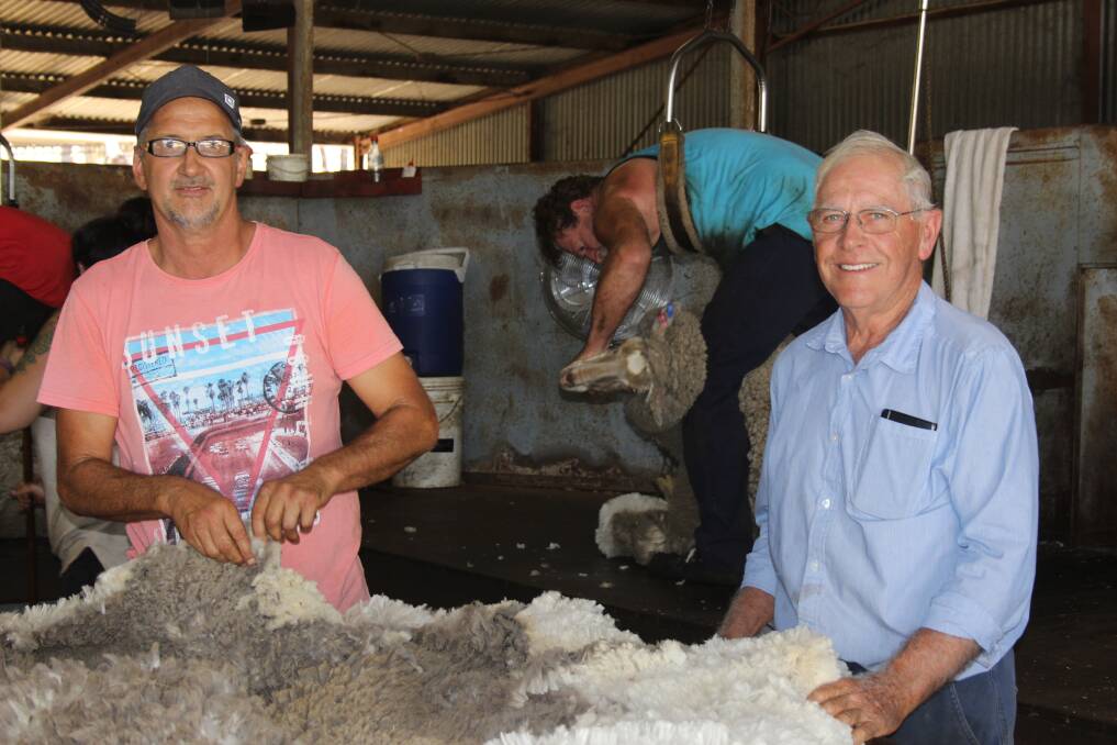 Pingelly Shearing contractor Rob Cristinelli (left) with Wandering farmer Ian Turton looking over the Merino fleece after shearing.
