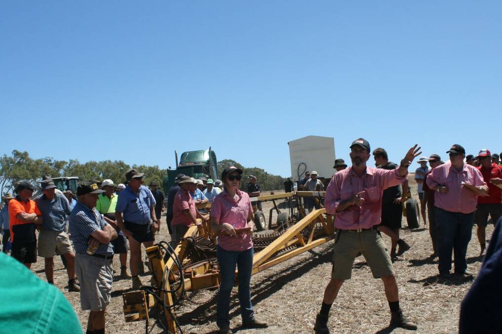 Auctioneer Dean Hubbard (centre) takes bids on a Phoenix Prickle harrow before bringing down the hammer at $9500. It sold to Yongarloo Farming, Morawa.