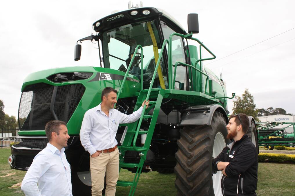  Goldacres general manager Roger Richards (left), sales and marketing manager Stephen Richards and mechanical engineer Coen Turner ready to show visitors over the company's new flagship self-propelled boomsprayer, the G8 Super Cruiser. 